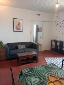 ein Wohnzimmer mit einem Sofa und einem Couchtisch in der Unterkunft Maison EL Marielle in Vierzon