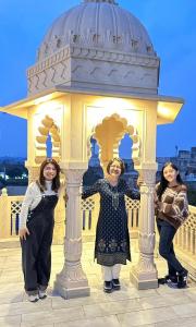 three women standing in front of a gazebo at Gupta Vilas - A Boutique Homestay in Agra
