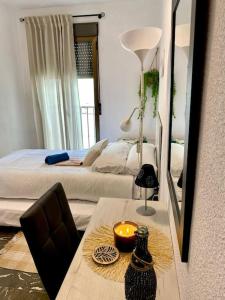 a bedroom with a bed and a table with a lamp at el Almendral in Jaén