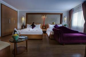En eller flere senge i et værelse på Eliana Ruby Hotel & Travel