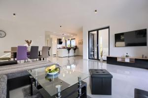 a living room with a couch and a table at Villa Delfin in Medulin