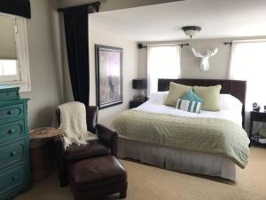 a bedroom with a bed and a chair at Beautiful Luxury Suite A of Shorewood Home in Shorewood