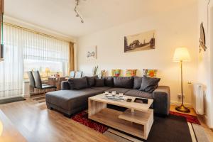 a living room with a couch and a table at Altes Forsthaus Königskrug in Braunlage