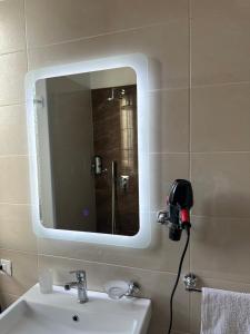 a bathroom with a mirror and a sink at Tirana Rent Apartment in Tirana +10 photos