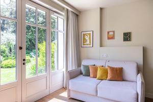 a living room with a couch and windows at La Villa du Moulleau in Arcachon