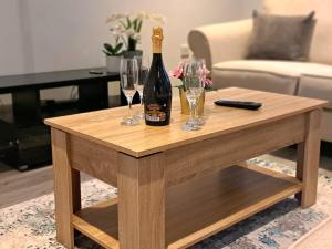 a bottle of champagne and glasses on a coffee table at Cozy, Charming 3-Bedroom Home in Chester- Free Parking- Sleeps Up To 6 in Chester