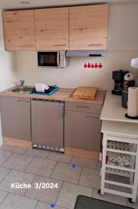 a small kitchen with a sink and a microwave at Bungalow Thiele in Döbeln