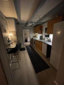 a kitchen with a refrigerator and a table in it at Drengstua in Kvaløya