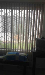 a bedroom with a window with vertical blinds at Casa Bella Suit in Salinas