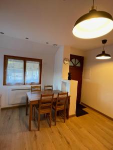 a kitchen and dining room with a table and chairs at Appartement proche des thermes d'Allevard les Bains in Saint-Pierre-dʼAllevard