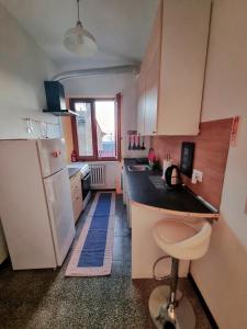 a kitchen with a white refrigerator and a sink at Casa Kundra Scarlino in Scarlino