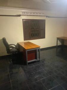 an empty room with a table and a chair at PiperZ in Entebbe