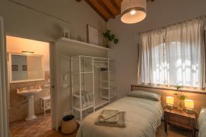 a bedroom with a bed and a sink and a window at Il Cipresso del Fossaccio in Asciano +33 photos