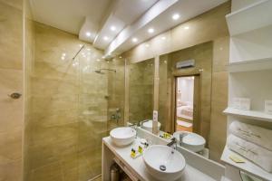 a bathroom with two sinks and a shower at Peninsula Luxury Suite in Zadar