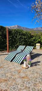 a green and white striped umbrella sitting on a patio at Legado De Zabala, Casa Rural in Laguardia