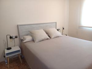 A bed or beds in a room at Atico duplex en Malgrat de Mar