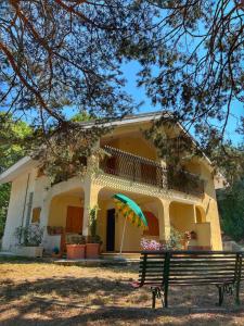 a house with a bench in front of it at Majella Green House in Roccamontepiano