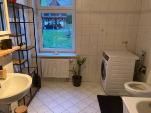 a bathroom with a sink and a toilet and a window at Alles Gute Wehlen in Stadt Wehlen