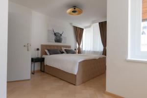 Postel nebo postele na pokoji v ubytování Deluxe Apartement Tirol