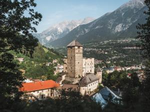 a castle in a town with mountains in the background at Deluxe Apartement Tirol in Landeck