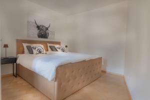 a bedroom with a large bed with a antelope on the wall at Deluxe Apartement Tirol in Landeck
