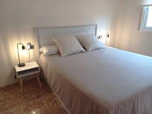 A bed or beds in a room at Atico duplex en Malgrat de Mar
