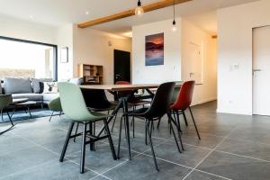 a dining room with a table and chairs at Les Terrasses du Noirmont 2 in Les Rousses