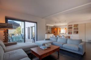 a living room with a couch and a table at VILLA KIM SISCU a 300m de la plage in Sisco