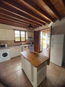 a kitchen with white cabinets and a wooden counter top at The Olympians Villas in Polis Chrysochous