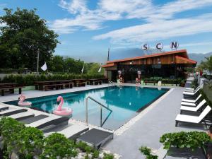 a swimming pool with pink flamingos in a building at SCN Resort and Spa Rayong in Ban Chang