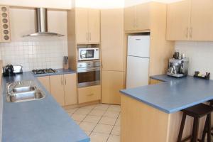 a kitchen with a blue counter top and appliances at The Lighthouse - Beachfront Accommodation in Port Hughes