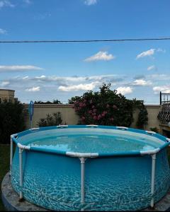 a large blue swimming pool in a yard at Seaview Villa Buzovna Sameya in Buzovna