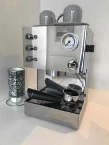 a coffee maker with two cups on a counter at Sunny Mokotow - apartment near the metro in Warsaw