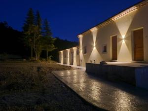 a building with lights on the side of it at night at Tenuta Barone in Duronia