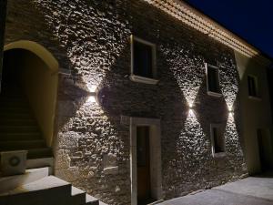 a brick building with lights on the side of it at Tenuta Barone in Duronia