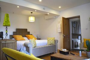 a bedroom with a bed with yellow and blue pillows at Manoir Drissia - Tours Centre, France in Saint-Avertin