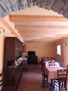 a dining room with tables and chairs and a ceiling at Tenuta Barone in Duronia