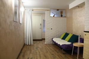 a small living room with a couch and a table at Old Town Apartment with a separate entrance in Kaunas