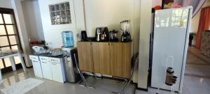 a kitchen with a refrigerator and a counter with a blender at Hostel de Gaia in Santa Cruz do Sul