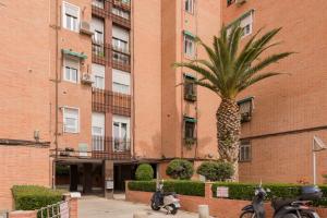 a pineapple palm tree in front of a building at Sunlit cosy haven a spacious treasure to be discovered in Madrid