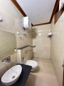 a bathroom with a white toilet and a sink at Gupta Vilas - A Boutique Homestay in Agra