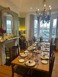 a wooden table with chairs and a dining room at Seaside Holiday Home, Ramsgate, Latimer House in Ramsgate