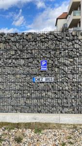 a stone fence with a parking sign on it at Chez Amis Arena in Leipzig