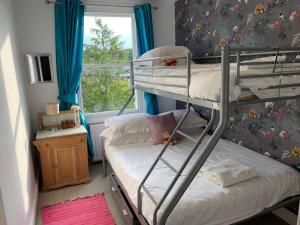 a bedroom with two bunk beds and a window at Seaside Holiday Home, Ramsgate, Latimer House in Ramsgate