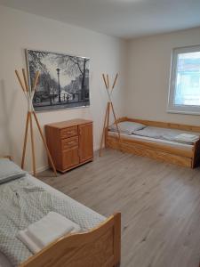 Postel nebo postele na pokoji v ubytování BÖJTÖS apartmány NESVADY