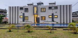 a house with a swimming pool in front of it at ANILLAH APPARTMENTS in Centre de Flacq