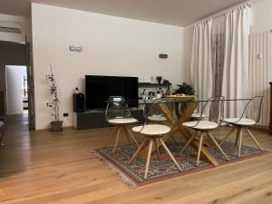 a living room with a dining table and chairs at Interno 12 Sweet Home in Verona