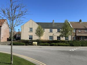 an empty street in front of a large building at Arthurs Escape - Part of the The Bay Filey Holiday Village with pool, gym and direct beach access, pub, restaurant, tennis and meadows walks in Filey