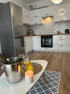 a kitchen with a table with a candle on it at Apartament White glove Nowe Zatorze in Olsztyn