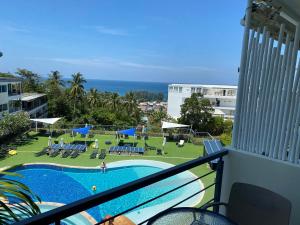 a view of a swimming pool from a balcony at Seaview Apartments - Karon Beach in Ban Karon